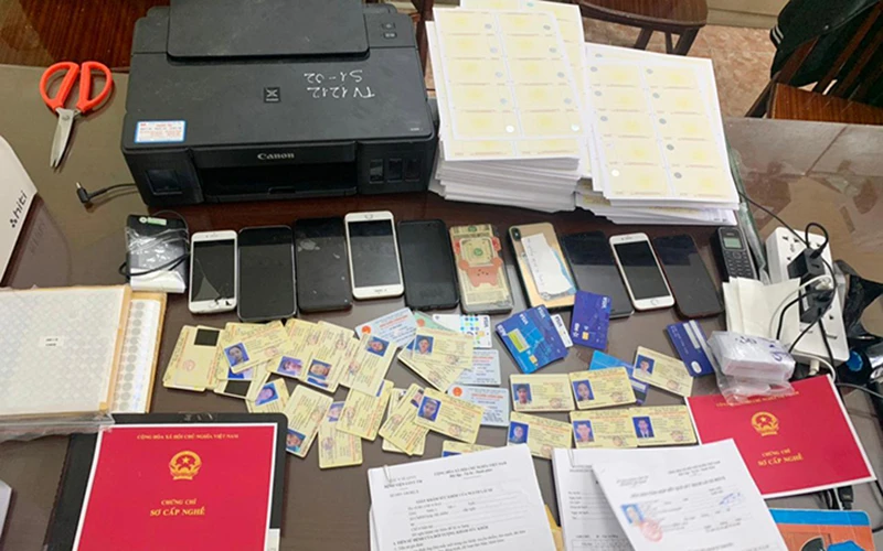 Một phần tang vật vụ án triệt phá ổ nhóm chuyên sản xuất các loại giấy phép lái xe giả tại Hà Nội. Ảnh: Báo Công an nhân dân