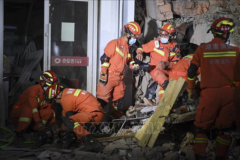 Nhân viên cứu hộ tìm kiếm nạn nhân trong vụ sập nhà ở thành phố Trường Sa, tỉnh Hồ Nam, Trung Quốc, ngày 29/4/2022. (Ảnh: AFP/TTXVN)