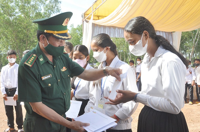 Đại tá Hoàng Văn Thành, Phó Chính ủy Bộ đội Biên phòng tỉnh Bình Phước trao tặng 50 suất học bổng cho học sinh nghèo Campuchia.