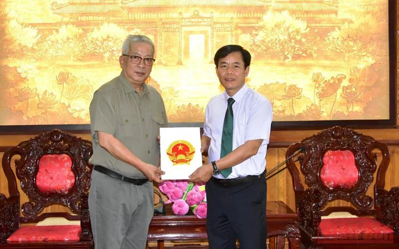 Chủ tịch Ủy ban nhân dân tỉnh Thừa Thiên Huế Nguyễn Văn Phương trao quyết định cho ông Nguyễn Chí Vịnh - đại diện gia đình Đại tướng Nguyễn Chí Thanh.