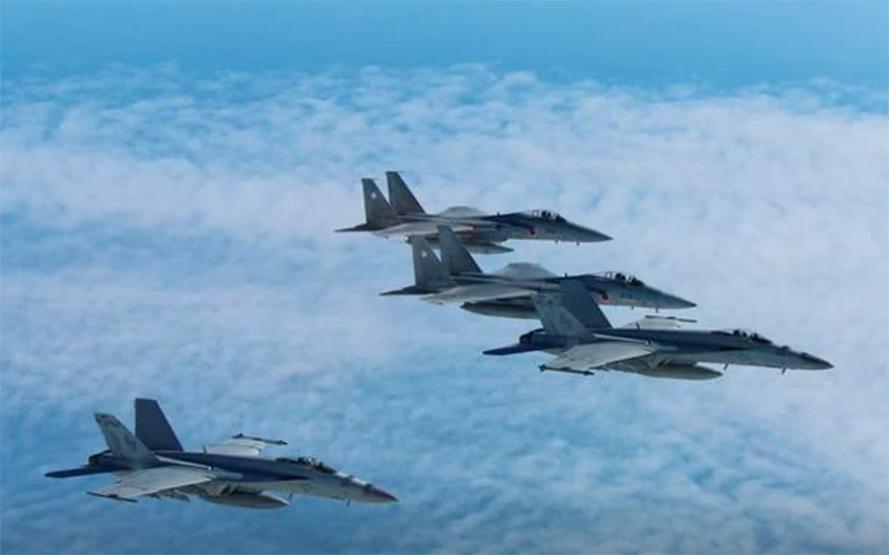Máy bay chiến đấu F-15 của Lực lượng Phòng vệ Nhật Bản (trên cùng và thứ 2 từ trên xuống) tiến hành một cuộc tập trận trên không với máy bay F/A 18 Hornet của Hải quân Mỹ tại Nhật Bản. (Ảnh do Văn phòng Tham mưu Không quân của Bộ Quốc phòng Nhật Bản công bố ngày 13/11/2017)
