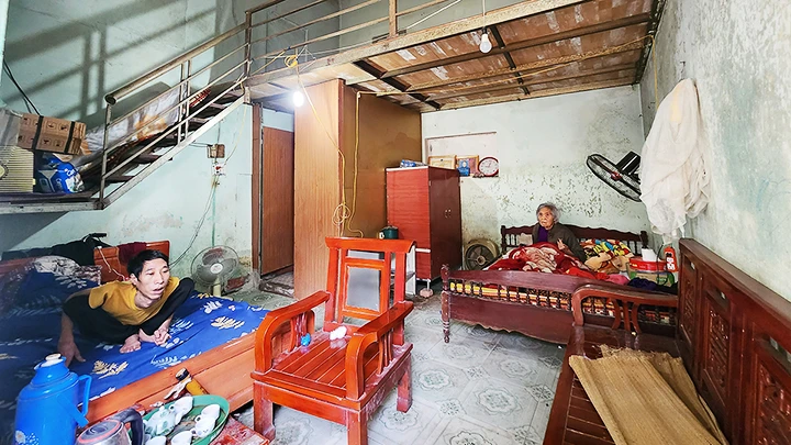 Anh Nguyễn Văn Dũng (bị bại liệt) cùng mẹ sống trong căn nhà tồi tàn mong chờ được tái định cư.