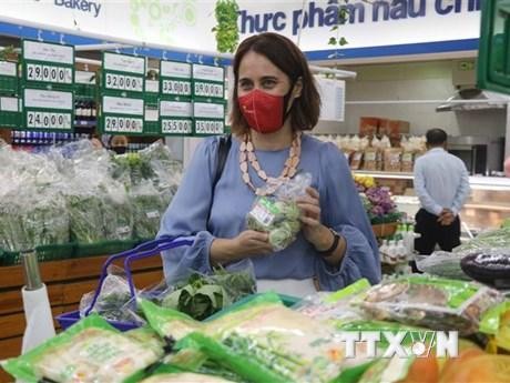Đại sứ New Zealand tại Việt Nam Tredene Dobson mua rau an toàn tại siêu thị Co.op Mart Quy Nhơn do nông dân Bình Định sản xuất từ dự án Rau an toàn Bình Định. (Ảnh: Kha Phạm/TTXVN)