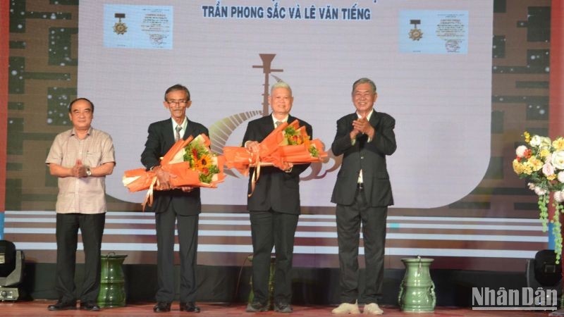Đại diện gia đình nghệ nhân Trần Phong Sắc và nghệ nhân Lê Văn Tiếng nhận quyết định truy tặng danh hiệu Nghệ nhân dân gian.