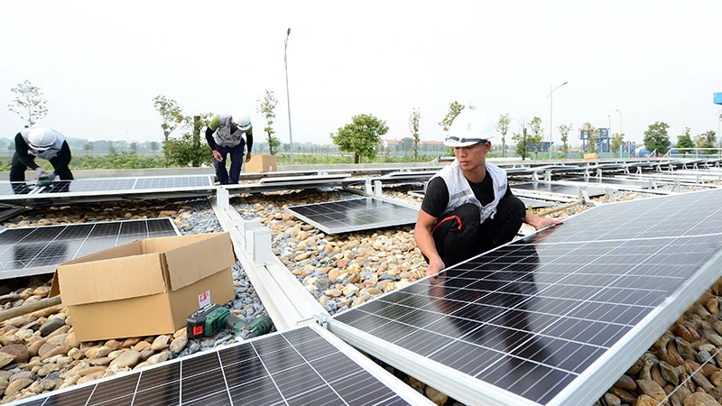 Lắp đặt điện mặt trời áp mái tại Nhà máy nước mặt Sông Đuống. (Ảnh TRẦN QUỐC)