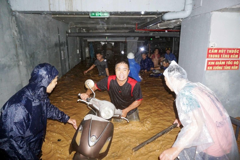 Mưa ngập hầu hết khu vực thuộc TP Đà Nẵng. Trong ảnh: Người dân chuyển xe máy ra khỏi tầng hầm ngập nước. (Ảnh ANH ĐÀO)