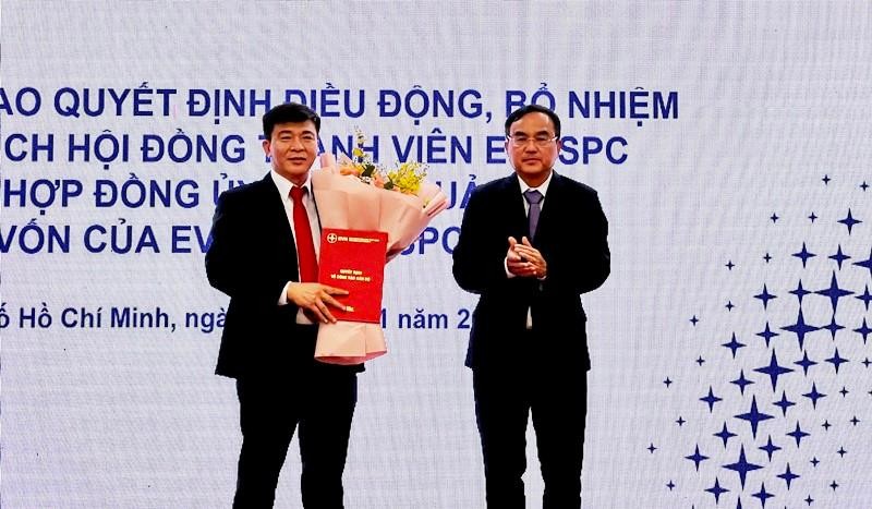 Chủ tịch EVN Dương Quang Thành tặng hoa chúc mừng tân Chủ tịch Hội đồng thành viên EVNSPC Lê Văn Trang. 