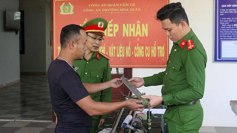 Người dân đến giao nộp vũ khí thô sơ cho Công an phường Hòa Xuân, quận Cẩm Lệ, thành phố Đà Nẵng. (Ảnh ĐINH NGA)