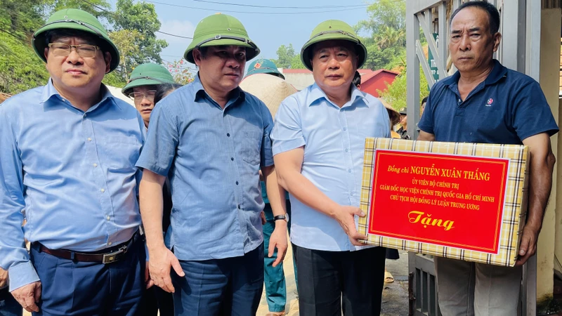 Đồng chí Nguyễn Xuân Thắng trao hỗ trợ cho người dân bị thiên tai tại phường Minh Tân thành phố Yên Bái. (Ảnh: THANH SƠN)