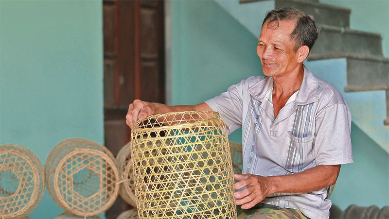 Ông Trần Thương bên những chiếc lờ cá vừa hoàn thiện. 