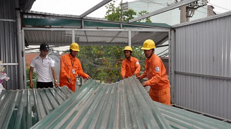 Tổng Công ty Điện lực Hà Nội hỗ trợ tháo dỡ công trình vi phạm. Ảnh: Hoa Việt Cường
