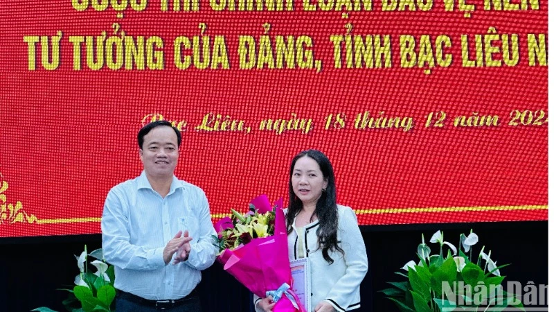 Đồng chí Huỳnh Quốc Việt, Ủy viên dự khuyết Trung ương Đảng, Phó Bí thư Thường trực Tỉnh ủy Bạc Liêu, trao giải Nhất cuộc thi chính luận Bảo vệ nền tảng tư tưởng của Đảng cho tác giả Tuyết Thanh (Báo Bạc Liêu). (Ảnh: TRỌNG DUY)