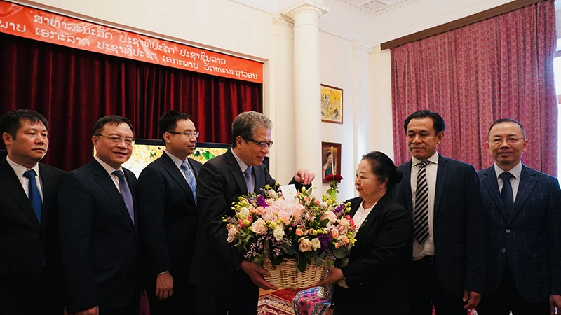 Đại sứ Đặng Minh Khôi trao lẵng hoa tặng Đại sứ Lào Vilavanh Yiapoher. (Ảnh: THÙY VÂN)