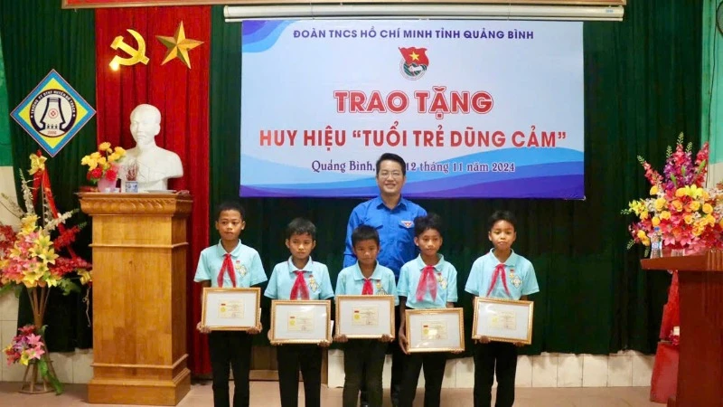 Phó Bí thư Tỉnh Đoàn, Chủ tịch Hội đồng Đội tỉnh Quảng Bình Đinh Trung Hiếu trao tặng Huy hiệu tuổi trẻ dũng cảm cho 5 đội viên.