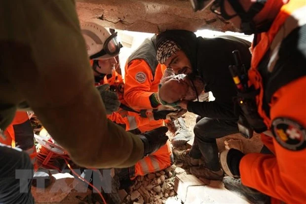 Lực lượng cứu hộ giải cứu em bé 4 tháng tuổi khỏi đống đổ nát sau trận động đất tại Antakya, tỉnh Hatay, Thổ Nhĩ Kỳ, ngày 8/2/2023. (Ảnh: AFP/TTXVN)