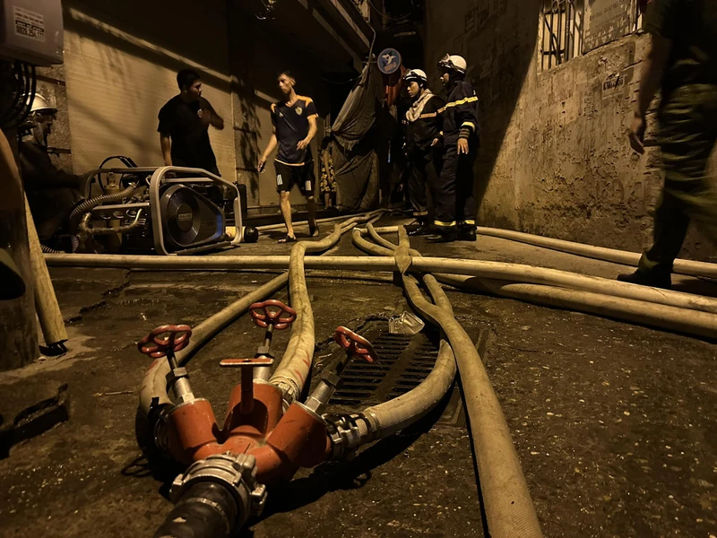 Cảnh sát phòng cháy chữa cháy dẫn nước vào sâu hiện trường. (Ảnh: CTV Nguyễn Hải)