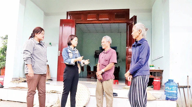 Cán bộ huyện Krông Bông và thị trấn Krông Kmar cùng vợ chồng ông Mai Văn Trung trước ngôi nhà mới có một phần kinh phí từ Quỹ tiết kiệm làm theo lời Bác.