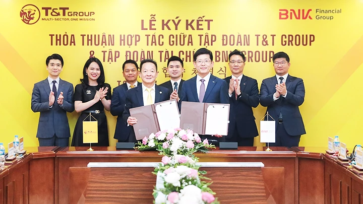  Ông Đỗ Quang Hiển, Chủ tịch UBCL Tập đoàn T&T Group (bên trái) và ông Bin Dae-in, Chủ tịch HĐQT kiêm TGĐ Tập đoàn tài chính BNK (bên phải) trao thỏa thuận hợp tác với sự chứng kiến của đại diện lãnh đạo hai Tập đoàn.