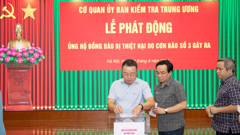 Các đồng chí lãnh đạo Ủy ban Kiểm tra Trung ương tham gia chia sẻ khó khăn với đồng bào bị thiệt hại do cơn bão số 3. (Ảnh: Sơn Tùng)