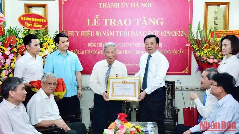 Bí thư Thành ủy Hà Nội trao Huy hiệu 80 năm tuổi Đảng tặng đồng chí Vũ Oanh.