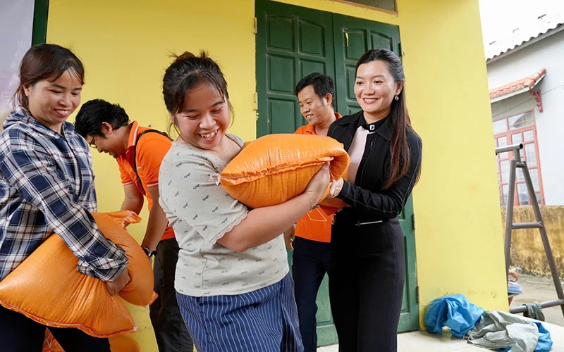 Bà Nguyễn Ngọc Ánh - Phó Chủ tịch Tập đoàn Kim Oanh trao 20 kg gạo/hộ tận tay bà con vùng lũ.