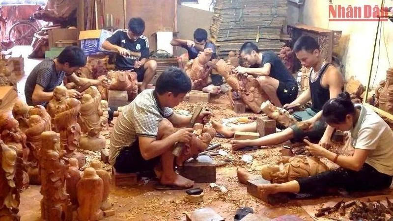 Sản xuất đồ gỗ mỹ nghệ tại làng nghề xã Hữu Bằng, huyện Thạch Thất (Hà Nội).