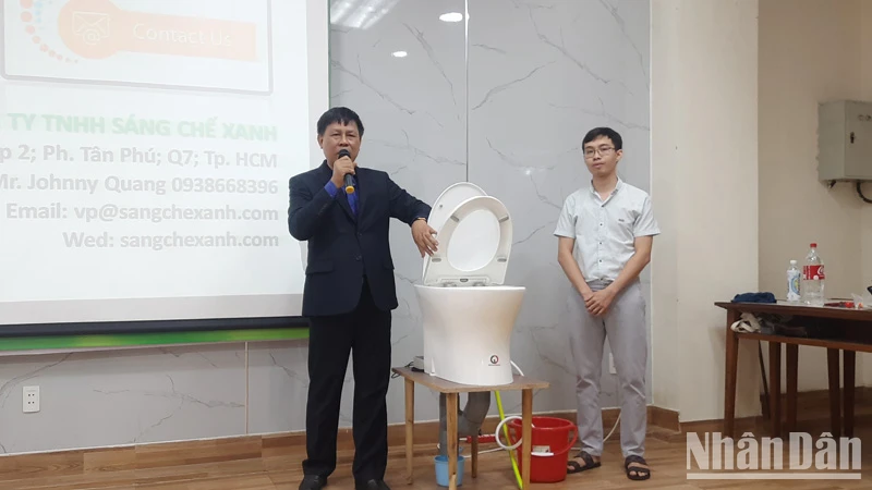 Ông Nguyễn Văn Nam (bên trái ảnh) thuyết trình về nguyên lý hoạt động của sáng chế hệ thống cơ-điện điều khiển bồn cầu xả nước.