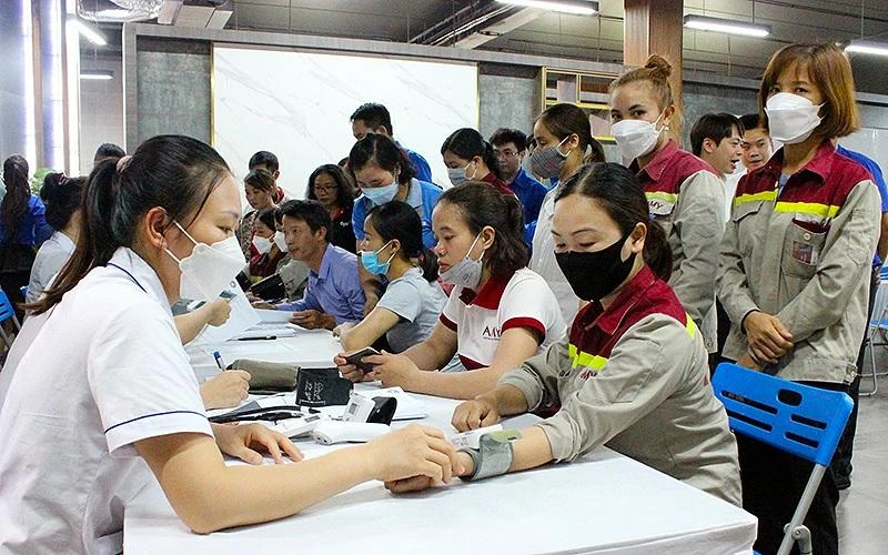 Các y, bác sĩ trẻ tình nguyện khám sàng lọc hậu Covid-19 cho thanh niên công nhân.