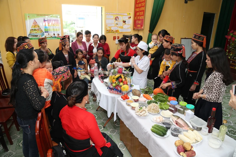 Người dân xã Hùng Đức, Hàm Yên, Tuyên Quang nghe hướng dẫn về cách chế biến bữa ăn đủ chất dinh dưỡng tốt để giúp trẻ phát triển toàn diện.