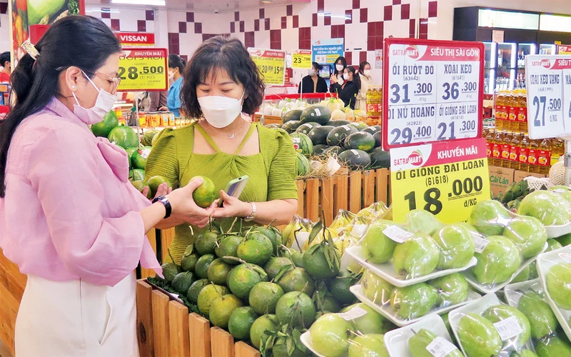 Người dân mua sắm hàng hóa (thực phẩm, trái cây) bình ổn thị trường tại một siêu thị ở Thành phố Hồ Chí Minh.