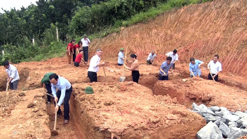 Cán bộ, hội viên các đoàn thể và người dân địa phương giúp công xây dựng nhà cho hộ nghèo.