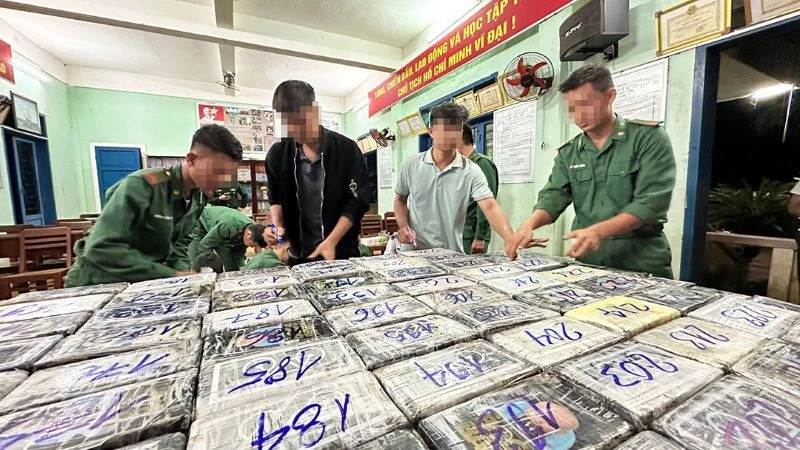 Lực lượng chức năng giám định 300 gói nghi ma túy trôi dạt tại bờ biển gành Nước Nhỉ, thôn Phước Thiện, xã Bình Hải, huyện Bình Sơn. (Ảnh: Thành Long)