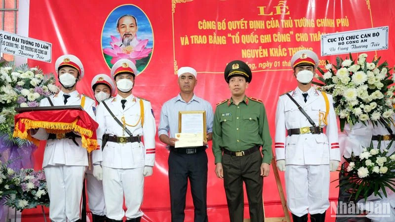 Thiếu tướng Lê Văn Tuyến trao quyết định của Bộ trưởng Công an cho thân nhân liệt sĩ-Trung tá Nguyễn Khắc Thường.