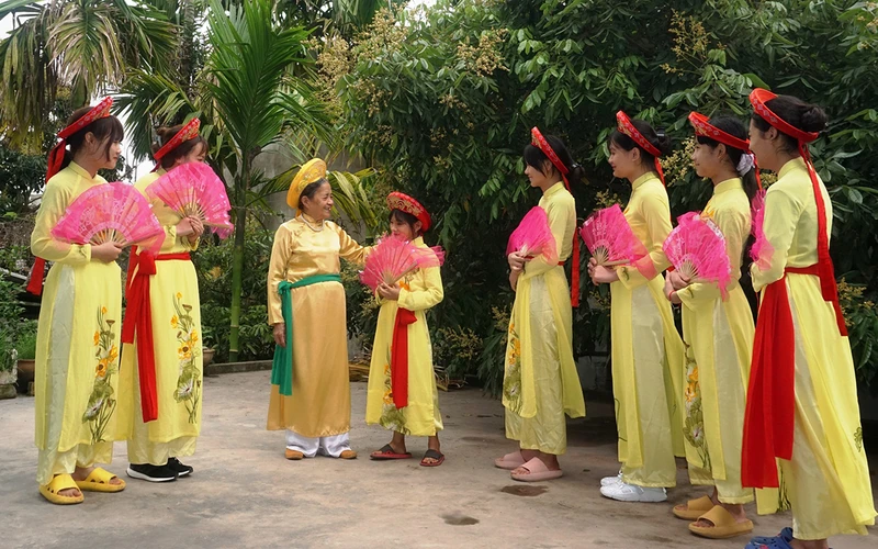 Nghệ nhân Trịnh Thị Phẩm (thứ ba từ phải sang) hướng dẫn học trò múa hát.