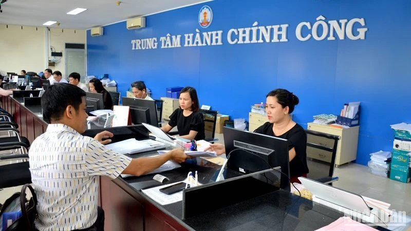 Công chức làm việc tại Trung tâm Hành chính công tỉnh Bình Thuận hướng dẫn và tiếp nhận hồ sơ của công dân, doanh nghiệp tại quầy giao dịch. (Ảnh: Đình Châu)