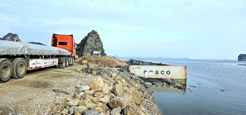 Đơn vị thi công sử dụng container làm kè chắn hạn chế đất đá trôi ra biển trong quá trình thi công. 