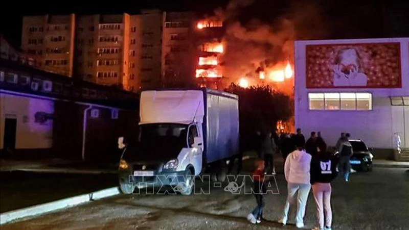 Khói lửa bốc lên từ tòa nhà sau khi một máy bay được cho là quân sự rơi xuống khu dân cư ở thành phố Yeysk, vùng Krasnodar, Tây Nam Nga tối 17/10/2022. (Ảnh: AFP/TTXVN)