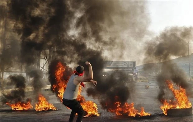 Người Palestine đụng độ với các lực lượng Israel tại Nablus ngày 29/5/2022. (Ảnh: AFP/TTXVN)