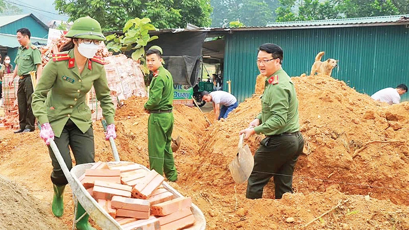 Cán bộ, chiến sĩ Công an tỉnh Tuyên Quang giúp dân làm nhà mới sau thiên tai. 