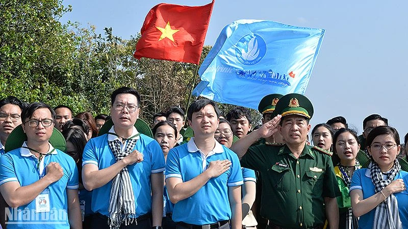 Các đại biểu thực hiện nghi lễ chào cờ chủ quyền tại Cột mốc số 0 ngã ba biên giới Việt Nam - Lào - Trung Quốc. 