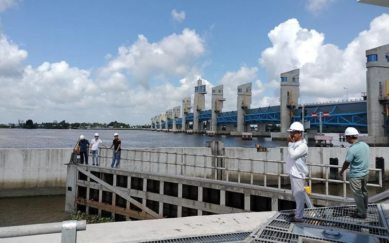 Các kỹ sư Công ty TNHH một thành viên Khai thác công trình thủy lợi miền nam vận hành hệ thống cống Cái Lớn. (Ảnh VĂN LÚA)