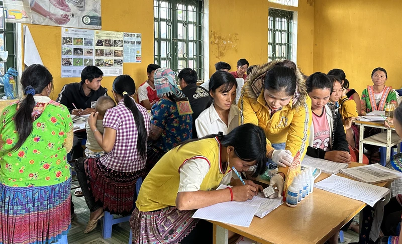 Giảng viên hướng dẫn học viên lớp đào tạo nghề tại bản Hua Huổi Luông cách ghi chép lịch tiêm phòng bệnh cho vật nuôi.