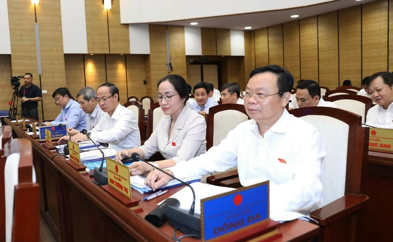 Các đại biểu bấm nút thông qua nghị quyết.