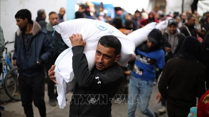 Người tị nạn Palestine nhận hàng cứu trợ từ UNRWA ở thành phố Rafah, Dải Gaza ngày 28/1/2024. Ảnh: THX/TTXVN