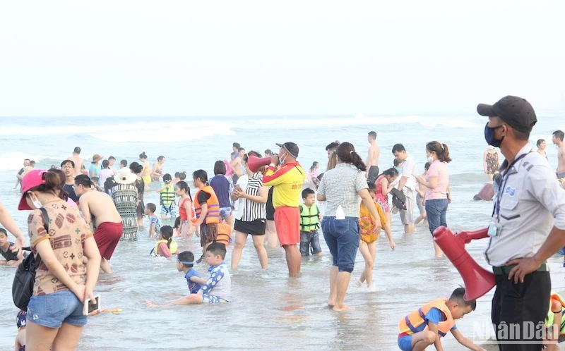 Lực lượng chức năng thành phố Đà Nẵng khuyến cáo người dân bảo vệ tài sản khi tắm biển. (Ảnh: ANH ĐÀO)