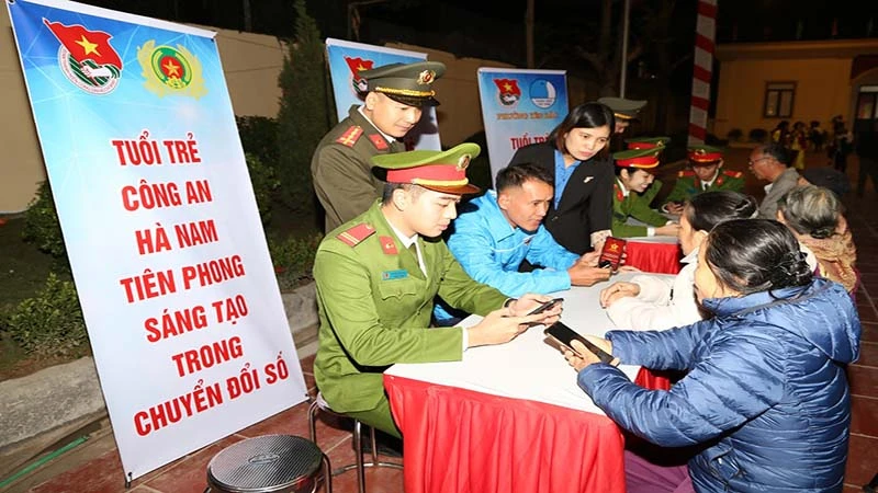 Cán bộ Công an hướng dẫn người dân cài đặt ứng dụng tài khoản định danh điện tử VNEID và thực hiện các bước khai báo tố giác tội phạm qua ứng dụng VNEID.