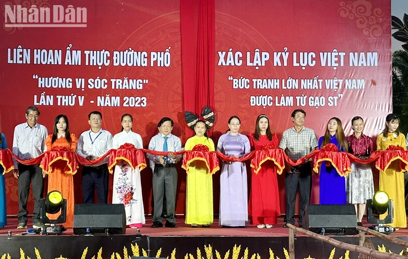 Ban tổ chức thực hiện nghi thức cắt băng khai mạc lễ hội đường phố và bức tranh gạo ST25.
