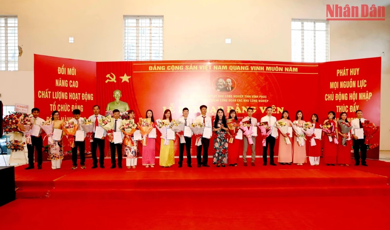 Bí thư Tỉnh ủy Hoàng Thị Thúy Lan trao quyết định kết nạp đảng và tặng hoa cho các đảng viên mới.