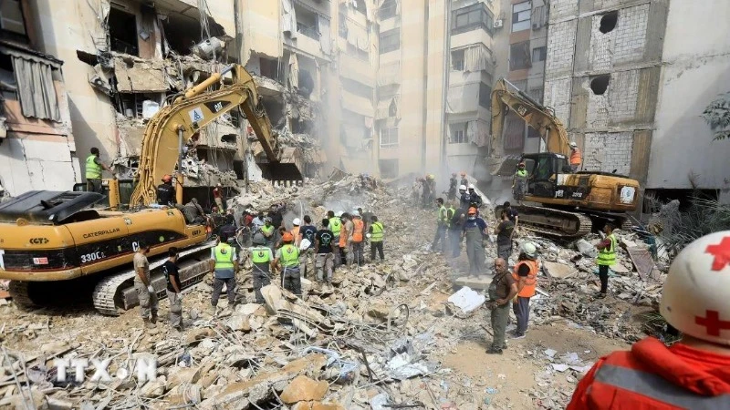 Lực lượng cứu hộ dọn dẹp đống đổ nát sau cuộc tập kích của Israel tại Beirut, Liban. (Ảnh: THX/TTXVN)