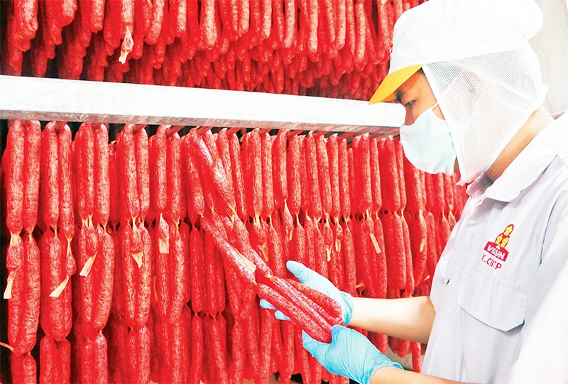 Công nhân Công ty VISSAN kiểm tra sản phẩm lạp xưởng phục vụ thị trường Tết Nguyên đán Quý Mão 2023. (Ảnh CTV)